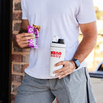 A guy holding OverEasy bar and OverEasy shaker.